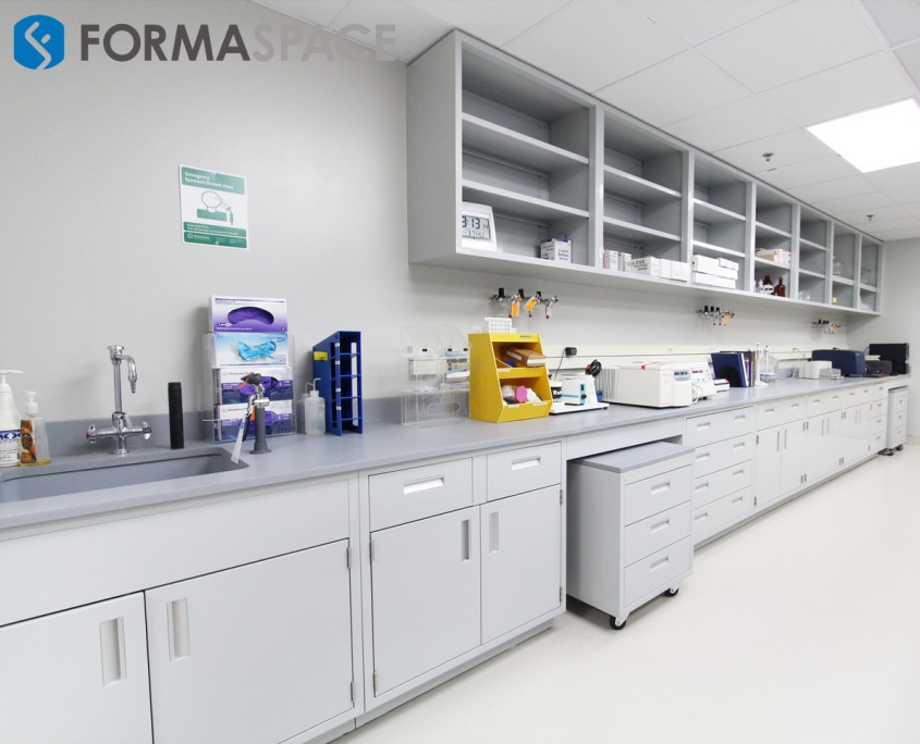 Fort Sam laboratory with fixed casework and upper cabinetry